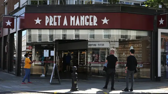 Customers wait outside a branch of Pret A Manger in London