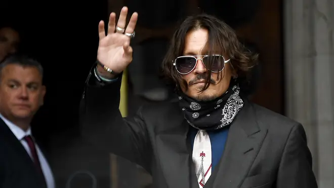 Johnny Depp waves outside the High Court in London