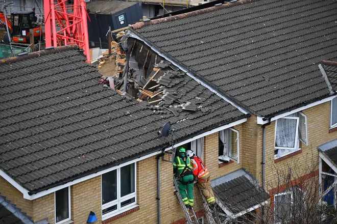 A woman has died after a crane collapsed onto some homes in Bow, east London