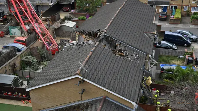 One woman died when the crane came down on houses