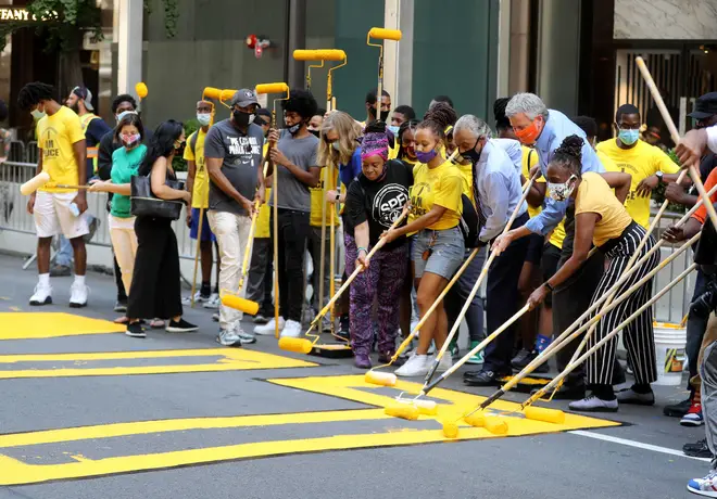 New York City Mayor Bill de Blasio, his wife Chirlane McCray, and the Rev. Al Sharpton all helped with the painting