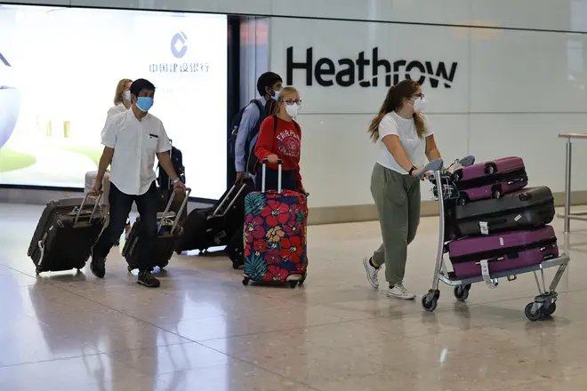 File photo: Passengers wearing PPE arrive at Terminal 2 of Heathrow airport