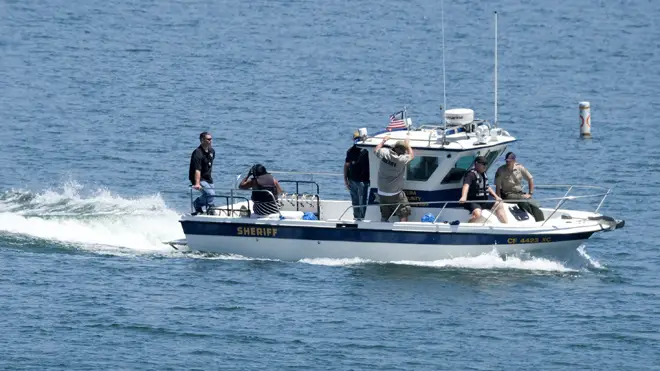 Naya Rivera's father, George Rivera, second from right, and mother Yolanda, second from left, with members of Ventura County Sheriff's Office, are seen in a boat after Naya Rivera's body was found in Lake Piru