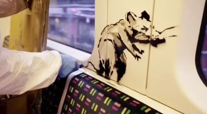 The artwork features Banksy's familiar rats