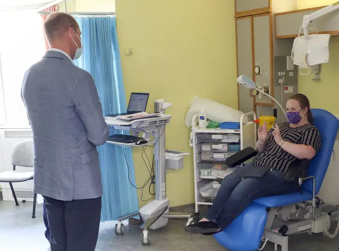 Prince William talks to a participant in the Oxford University Covid-19 vaccine trial