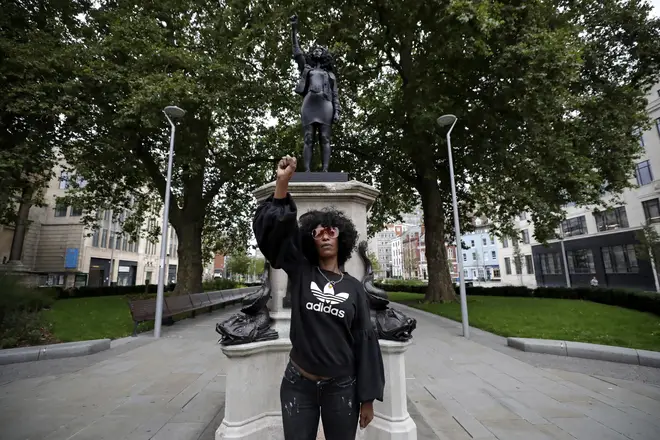 Jen Reid standing in front of the statue yesterday