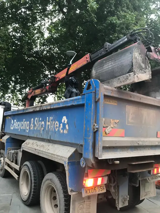 The statue was loaded into a skip lorry and taken away