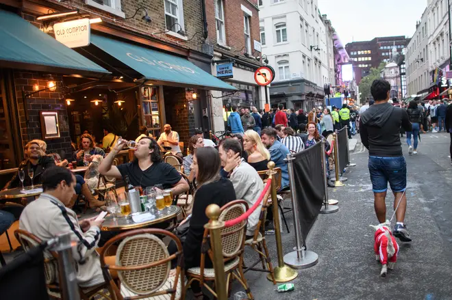 File photo: People eat and drink outdoors in Soho, London