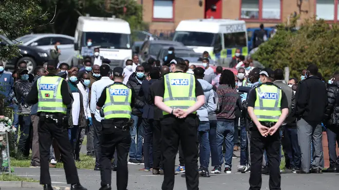 Police ensure mourners leave the graveyard ahead of the funeral