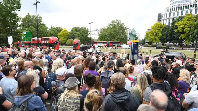 People attend a protest against the wearing of masks in Hyde Park, London