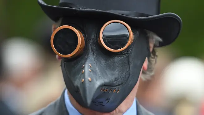 A man wearing a plague mask during the rally