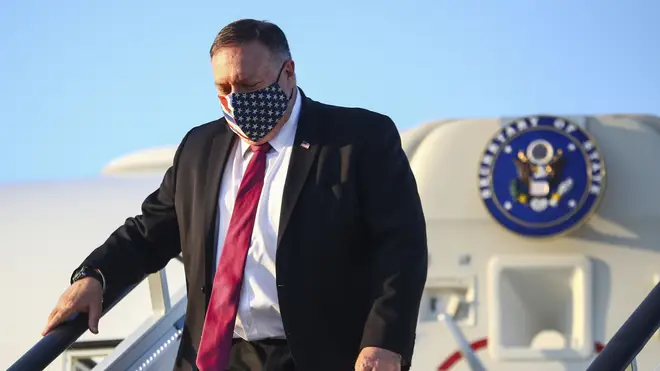 Mike Pompeo wears a stars and stripes face mask as he arrives in London for trade talks