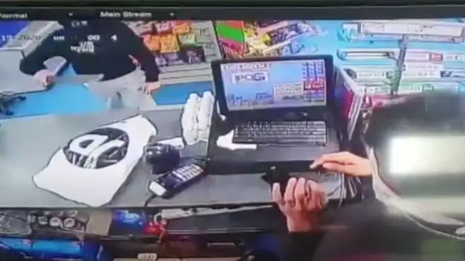 The man burst into the shop waving the large knife