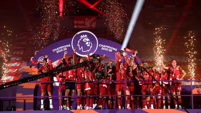 The triumphant team lift the trophy above their head