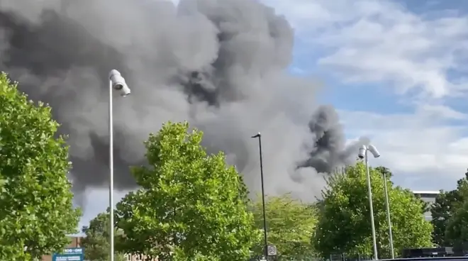 A "massive fire" has broken out in a shop with flats above in Park Royal, west London