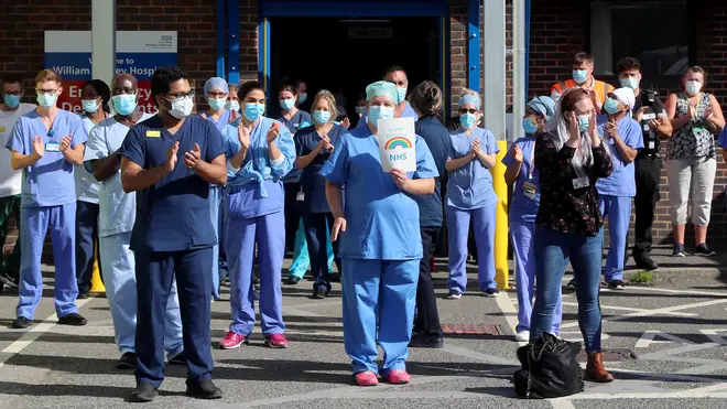 File photo: NHS staff outside the William Harvey Hospital in Ashford, Kent, join in the pause for applause to salute the NHS 72nd birthday