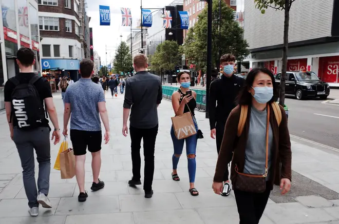 File photo: Shoppers wearing face masks walk along Oxford Street in London