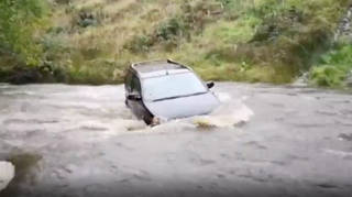 A car was swept away in a river in Carmarthenshire after heavy rain across Wales