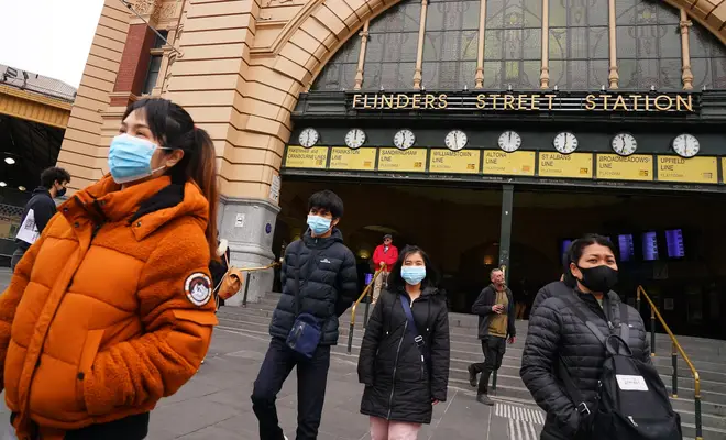 People wearing face masks outside Melbourne's iconic Flinders Street Station