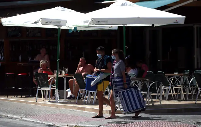 Tourists enjoy a drink at a terrace bar in the English district of Levante in Benidorm
