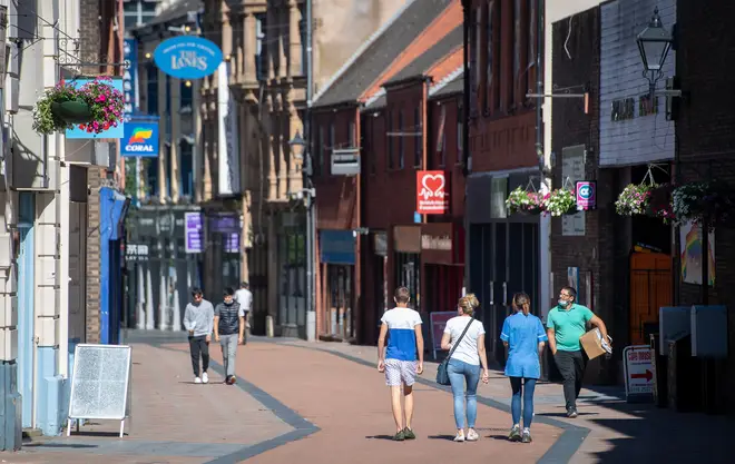 People walk along Silver Street in Leicester as a decision is due to be made on whether to lift the lockdown restrictions in the city