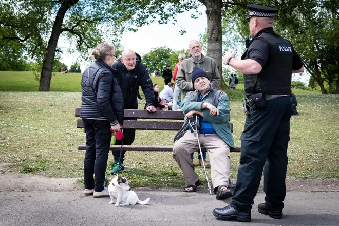 Police talk to people in Heaton Park, Manchester, about lockdown rules