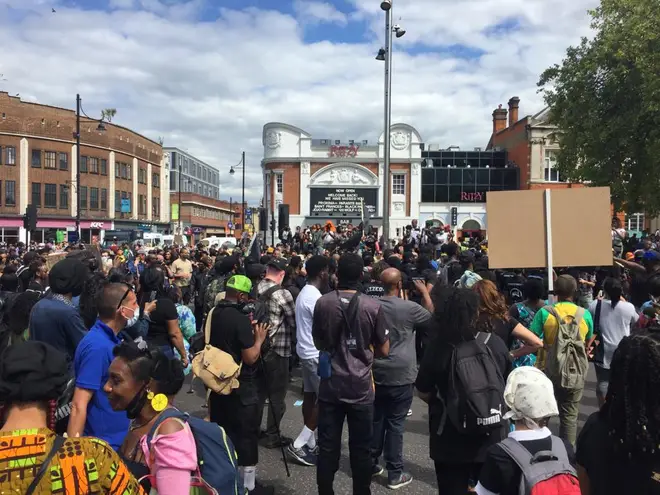 Hundreds have turned up to a protest in Brixton as police impose a curfew