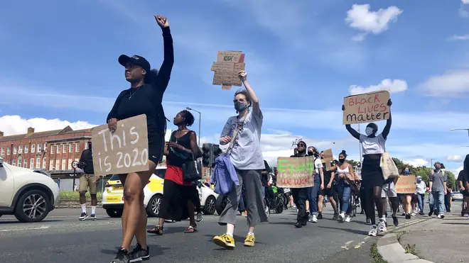 People marched down the road in protest against a hit-and-run which police say was racially aggravated