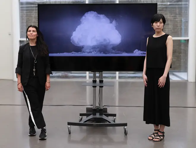 Artists Es Devlin and Machiko Weston pose next to their digital art collaboration 'The End of the World' at Imperial War Museum London