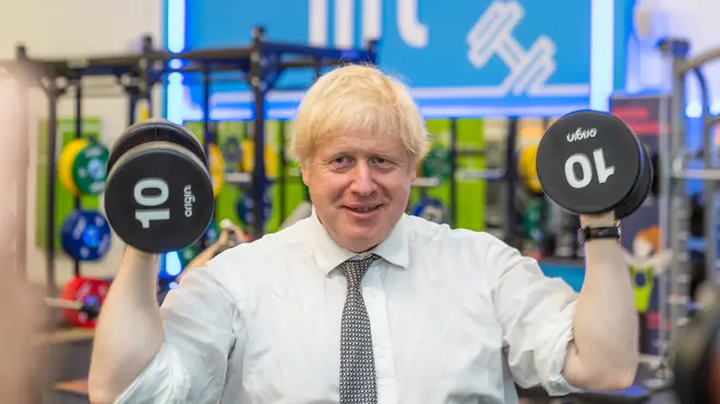 Boris Johnson taking on some 10kg weights for a shoulder press exercise