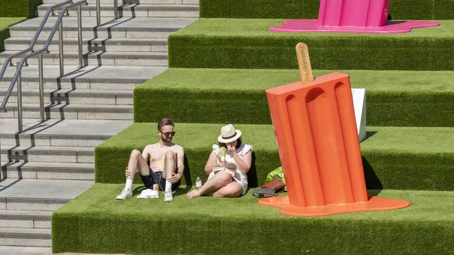 People seen enjoying the sun in Coal Drops Yard next to a giant ice lolly as temperatures soar
