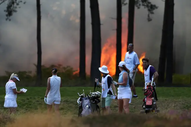 A "wall of flames" has halted play at a golf course in Surrey
