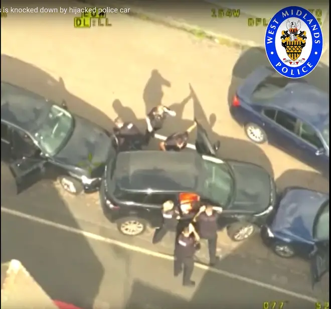 Videograb from police helicopter footage issued by West Midlands Police of police surrounding a Range Rover, stolen by Mubahsar Hussain