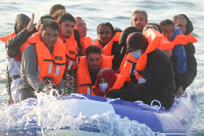 Border Force officers aboard HMC Hunter speak to group of people, thought to be migrants, after they were stopped as they crossed The Channel in a small boat headed in the direction of England.