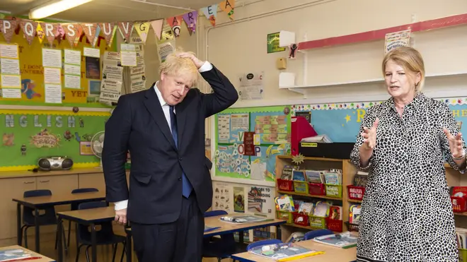 Head teacher Bernadette Matthews shows Prime Minister Boris Johnson the new measures being implemented to ensure children can return to school safely in September during his visit to St Joseph's Catholic Primary School in Upminster, east London