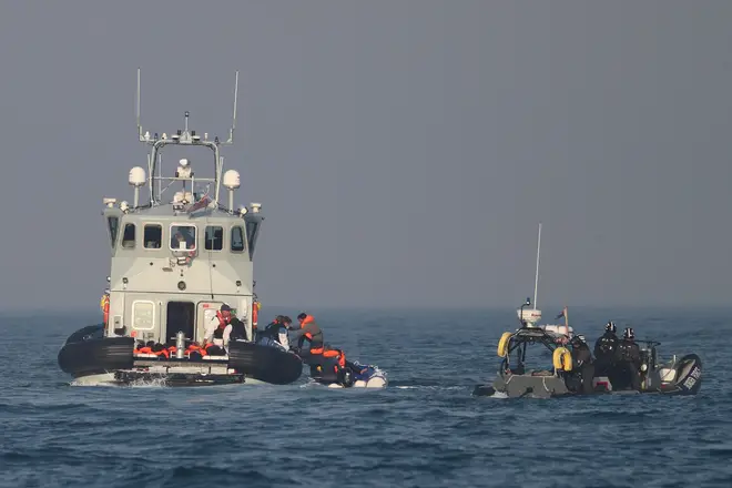 Border Force officers assist 20 Syrian migrants aboard HMC Hunter after they were stopped as they crossed the Channel in an inflatable dinghy headed in the direction of England.