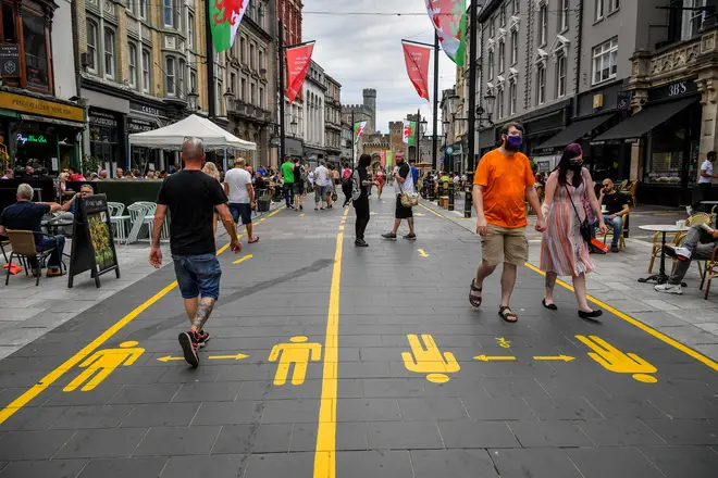 Yellow markings along the pedestrianised area of Cardiff city centre direct people to aid social distancing
