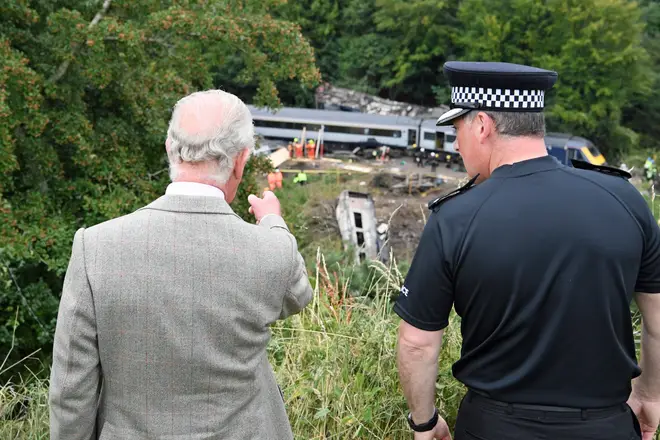 Prince Charles inspects the site of the train crash as he met with emergency workers