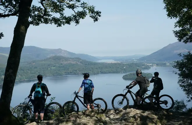 Cyclists marvelled at Derwentwater near Keswick, in the Lake District, on Saturday ahead of thunderstorms