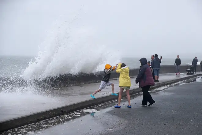 People are hit by waves on the Front Strand in Youghal, Co. Cork.