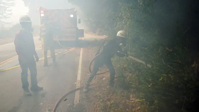 Civilian firefighters assist with tackling the flames in California