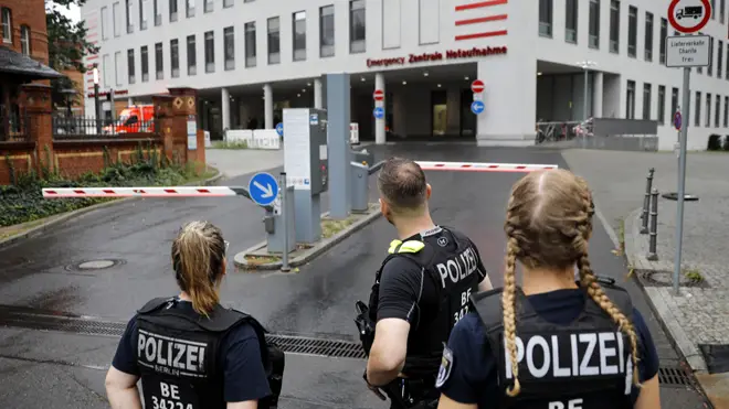 German police officers stand in front of the emergency entrance of the Berlin Charite hospital where Alexei Navalny is expected to arrive