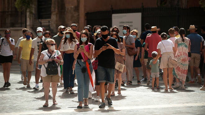 People wear protective masks in Malaga in Spain