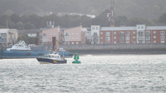 Southampton Harbour Master launch inspecting a buoy off Hythe, Hampshire, after twelve people were taken to hospital