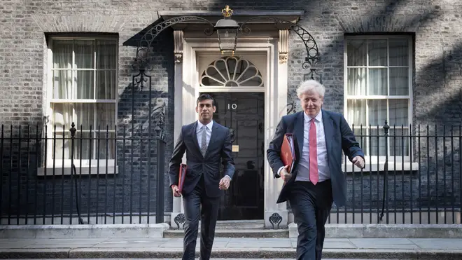 Mr Johnson, pictured with Chancellor Rishi Sunak, made his way back to work yesterday morning