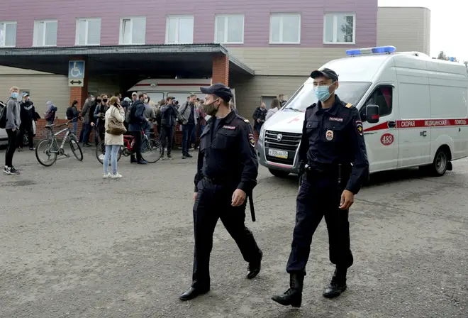 Police officers walk outside Omsk Ambulance Hospital No 1