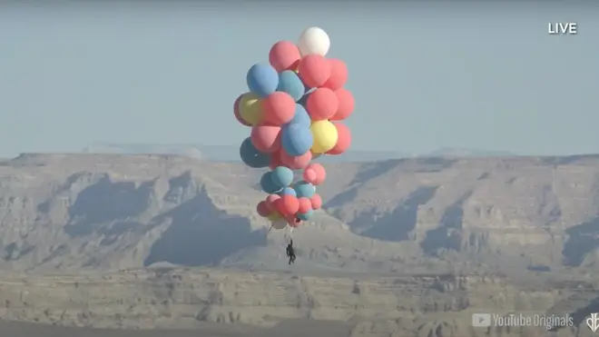 Is it a bird? Is it a plane? No it's David Blaine holding onto 52 helium balloons