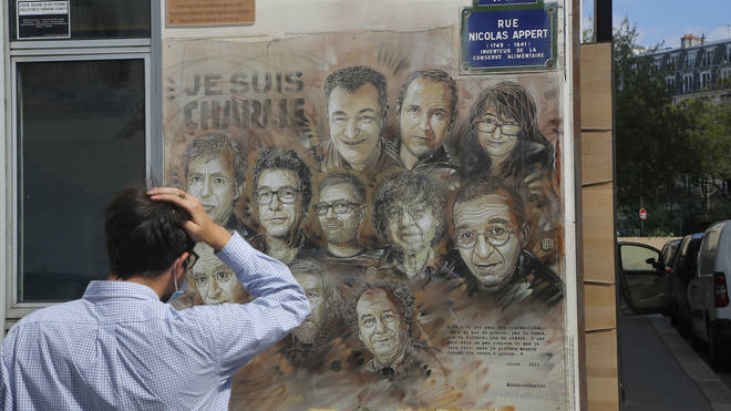 A man looks at a tribute to the members of the satirical newspaper Charlie Hebdo attack by jihadist gunmen in January 2015