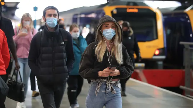 Commuters in masks arriving at Leeds railway station today