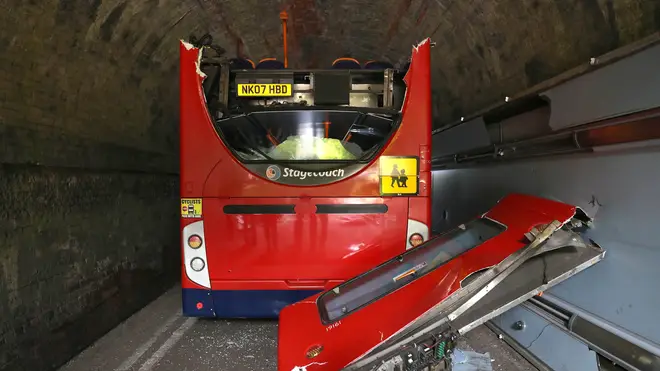 The roof of the bus was torn off as it crashed into the railway bridge